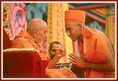 Swamishri blesses and gives the guru mantra to the newly initiated sadhus 