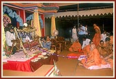 Swamishri rocks Shri Harikrishna Maharaj in the cradle to celebrate the birth of Bhagwan Swaminarayan