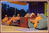 Swamishri and sadhus on the stage