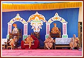 Swamishri and senior sadhus on stage during the pratishtha assembly