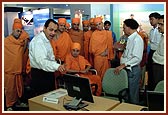 Then Swamishri is shown the Reliance InfoCom Exhibition