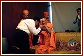Shri Mukesh Ambani is being blessed by Swamishri with a garland