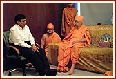 Swamishri and Shri Mukesh Ambani engaged in a dialogue
