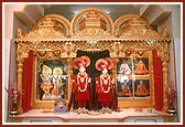 Deities in a decorative sinhasan