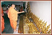 Swamishri sanctifies the kalashas and staffs for BAPS mandirs