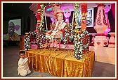 Murti of Shriji Maharaj placed on a beautifully decorated swing