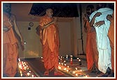 Humbly receiving the respects offered by sadhus and devotees