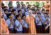 Swamishri with students having graduated in 10th grade from Pramukh Swami Vidya Mandir (school) in Sarangpur