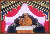 After his puja Swamishri participates by playing 'ghughra' while devotees of Badalpur sing bhajans