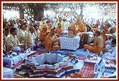 Swamishri and devotees perform arti during the yagna
