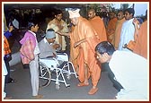 Blesses a disabled devotee