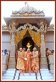 Descends the mandir steps