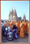 Swamishri sanctifies and blesses a new motorcycle and its owner respectively&nbsp;&nbsp;