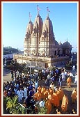 Swamishri sanctifies a new motorcycle on the precincts of BAPS Shri Swaminarayan Mandir, Tithal