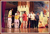 Youths present a drama during an evening assembly