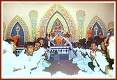 Tribal devotees garland Swamishri