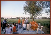 Swamishri observes the site plan on the land for the new BAPS Swaminarayan Mandir  