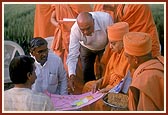 Swamishri observes the site plan on the land for the new BAPS Swaminarayan Mandir&nbsp;&nbsp;