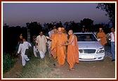 Swamishri sanctifies the land by sprinkling holy water of Akshar Deri