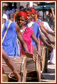 Tribal devotees donned in traditional garbs welcome Swamishri on his arrival to Poshina