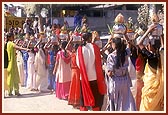 Tribal girls carrying the auspicious pots and coconuts for the welcome ceremony