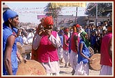 Tribal devotees donned in traditional garbs welcome Swamishri on his arrival to Poshina
