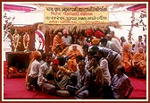 &nbsp;&nbsp;Tribal devotees of Poshina collectively honor Swamishri with a garland