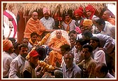 &nbsp;&nbsp;Tribal devotees of Poshina collectively honor Swamishri with a garland