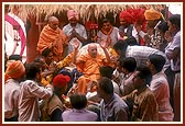 &nbsp;&nbsp;Tribal devotees of Poshina collectively honor Swamishri with a garland