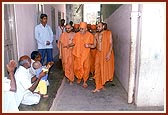 Swamishri blesses devotees, young and old, while on his way for darshan to the birthplace of Shastriji Maharaj