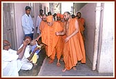 Swamishri blesses devotees, young and old, while on his way for darshan to the birthplace of Shastriji Maharaj