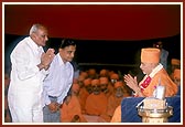On behalf of Charutar Vidya Mandal Shri C. L. Patel and Shri H. K. Patel garland and honor Swamishri
