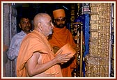 Swamishri at the old mandir engaged in darshan of Shri Harikrishna Maharaj and Shri Gopinath Dev