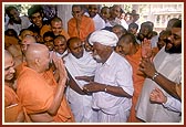 Swamishri is still weak after his fever. Shri Ragha Bharwad performs a traditional ritual of transferring Swamishri's illness onto himself by taking out his pagh and circling it around Swamishri's head 