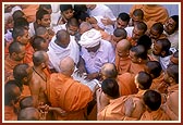 Swamishri sanctifies the computer of Shri Ragha Bharwad, village chief (sarpanch), given to him by the local government