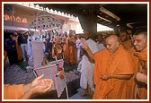 Swamishri rocks Shri Harikrishna Maharaj in a traditional decorative hindolo gifted by a devotee