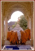 Sadhus eagerly absorbed in Swamishri's darshan while he proceeds for darshan towards the rang mandap