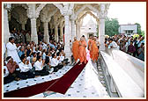 Prior to the morning puja devotees do darshan of Swamishri in the mandir pradakshina