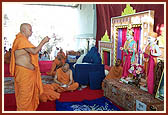Swamishri performs the murti-pratishtha arti of murtis for a BAPS Swaminarayan Mandir (hari mandir) in Surat