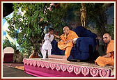 A child with Swamishri during the Children's Day program
