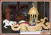 Swamishri presides over the symbolic celebration of Rath Yatra with Shri Harikrishna Maharaj in a decorated rath (chariot)