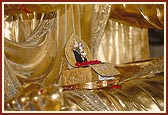 Shri Harikrishna Maharaj on the lap of the murti of Bhagwan Swaminarayan