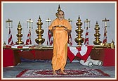 The mandir kalashas and flagstaffs arranged behind Swamishri's puja. Thereafter Swamishri performs pujan and arti 