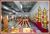 The mandir kalashas and flagstaffs arranged behind Swamishri's puja. Thereafter Swamishri performs pujan and arti 