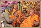 Swamishri blesses Shri Satish Gujaral, a renowned international artist and architect. With reference to Akshardham he said, "I am otherwise not a believer, but there are times when you see such a thing that you have to make yourself believe that there is something like Providence which gives man such power to create such a place."