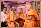 Swamishri presents a photo memento to Pujya Harinarayananand Swami of his visit to Akshardham