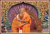 Swamishri garlands and blesses Ishwarcharan Swami for successfully coordinating the Akshardham project