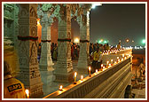 The mandir pradakshina is illuminated with candle lights