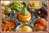 Varieties of sweets, 'farsan', cooked vegetables and cake modeled on Swaminarayan Akshardham and parikrama