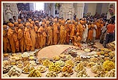 Sadhus having close darshan of the murtis and annakut